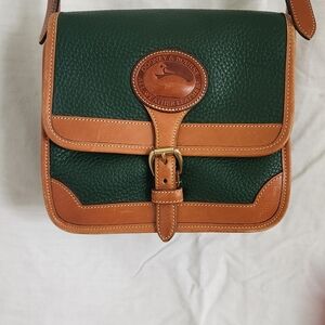 Vintage, green Dooney & Bourke Crossbody bag. It buckles in front very, unique!